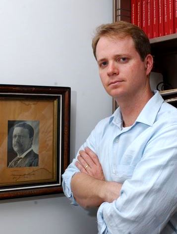 Professor Eric Raunchway with a photo of Teddy Roosevelt