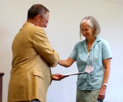 Professor JoAnne Engebrecht receives her award from Provost Ralph Hexter