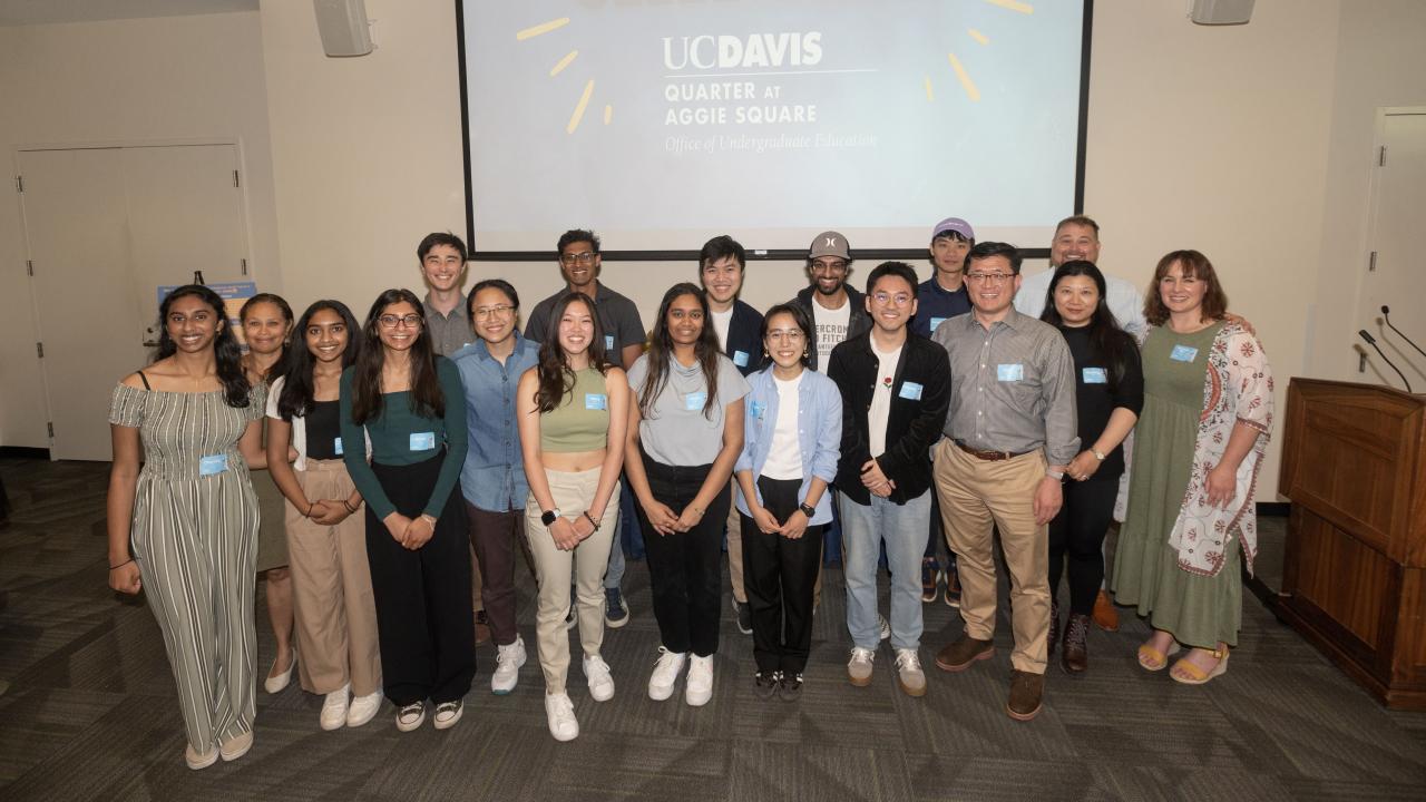 A group of people posing for a photo. Group is primarily UC Davis students.