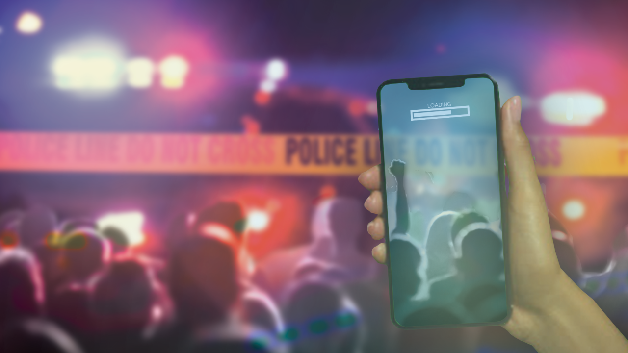 Image of iPhone filming at a police barrier