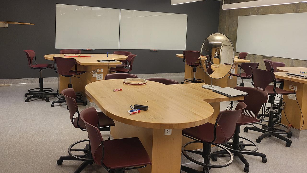 Updated lab room featuring new group work tables, stools and repainted walls.