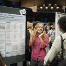 Student presenting a poster at a conference. 