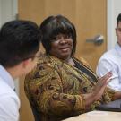 Cheryl Purifoy meets with two students. 