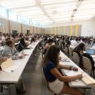 Large group of students sitting in rows in California Hall (classroom)